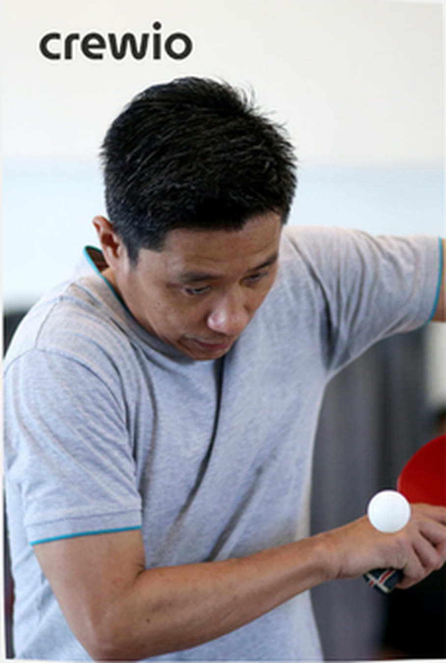 A table tennis coach training with a player
